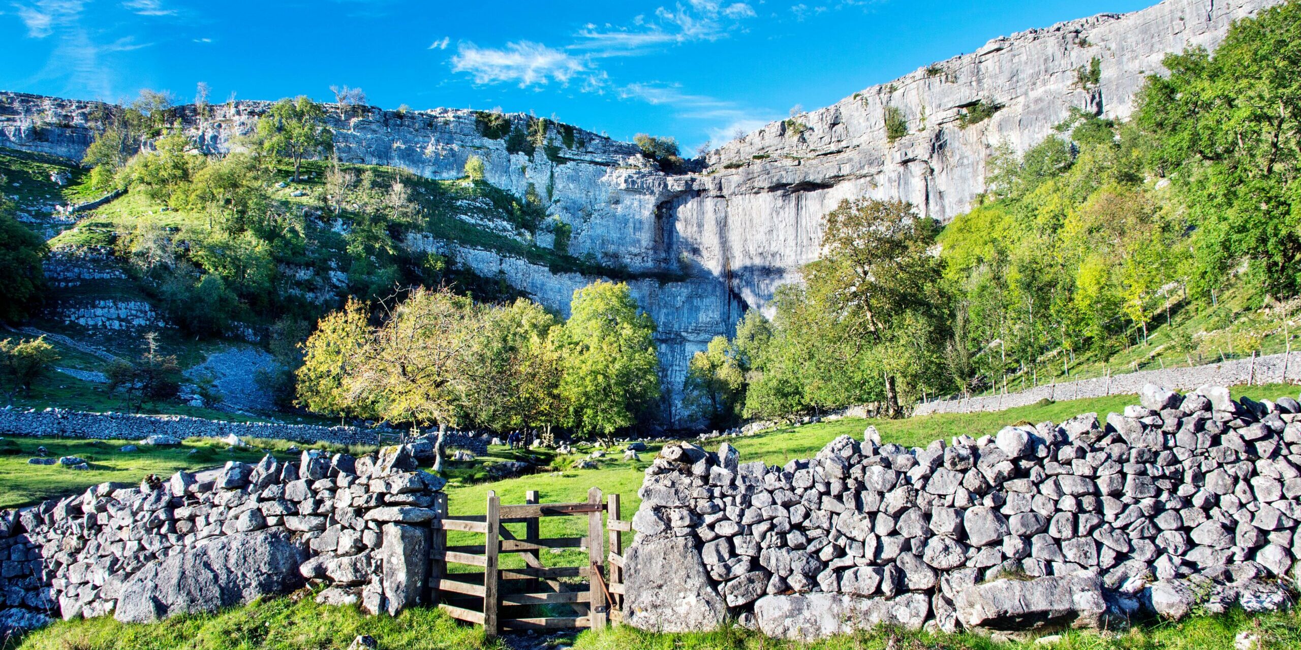 Malham Cove, a large vertical ampitheatre shaped cliff face formation in the Pennines