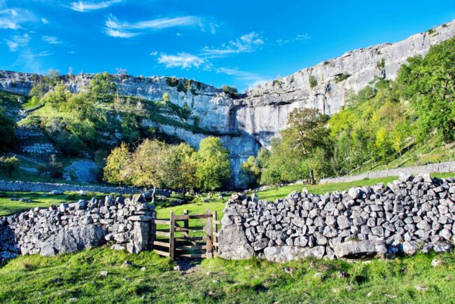 Malham Cove, a large vertical ampitheatre shaped cliff face formation in the Pennines